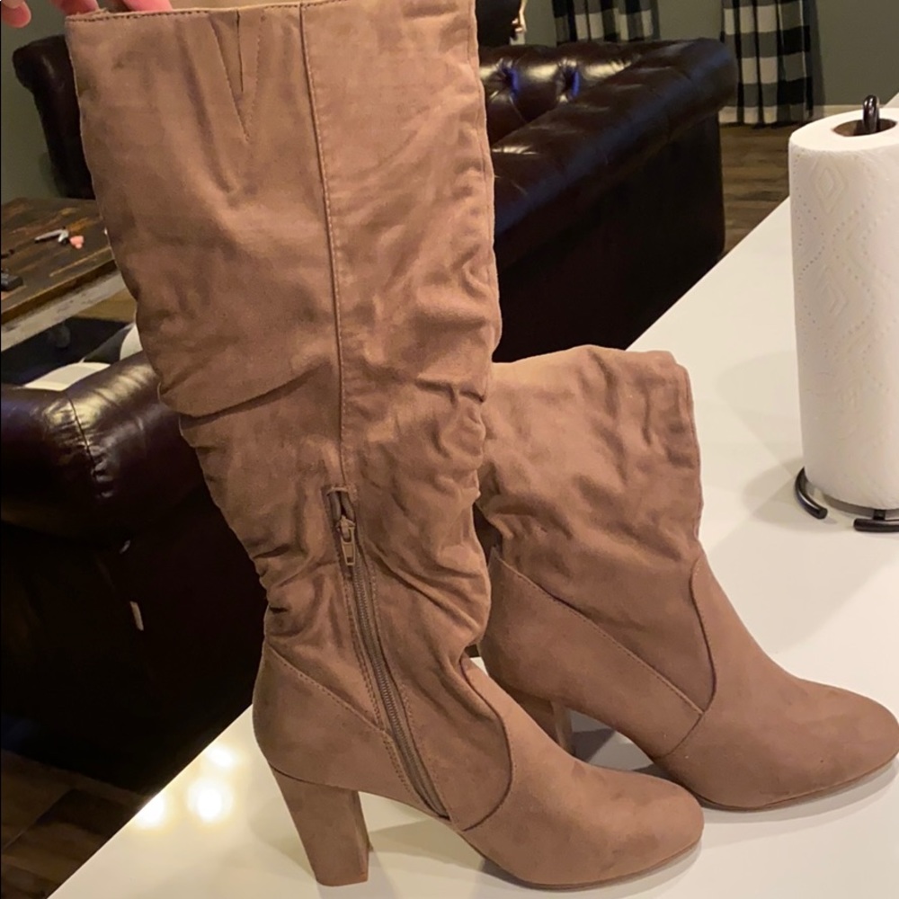 Cute knee boots. Never worn, stickers on bottom.
